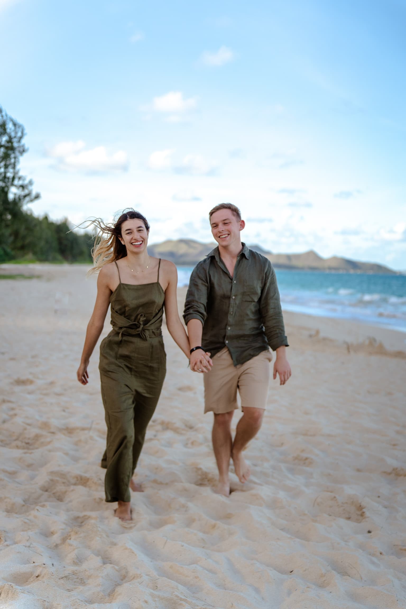 Walking hand in hand along the shore — Hawaii, December 2025