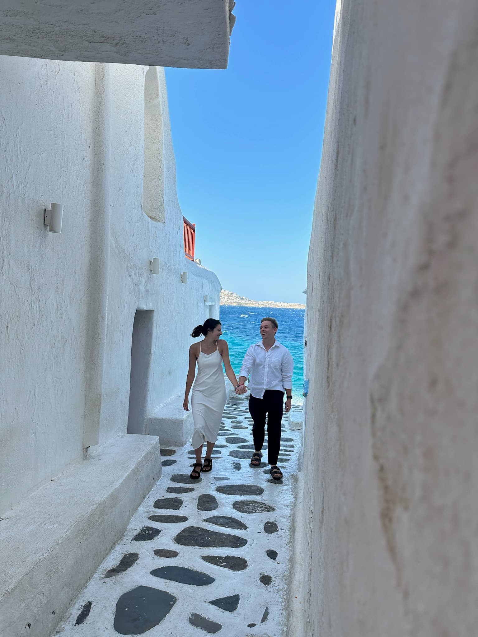 Facing each other in a Mykonos alley — September 2025